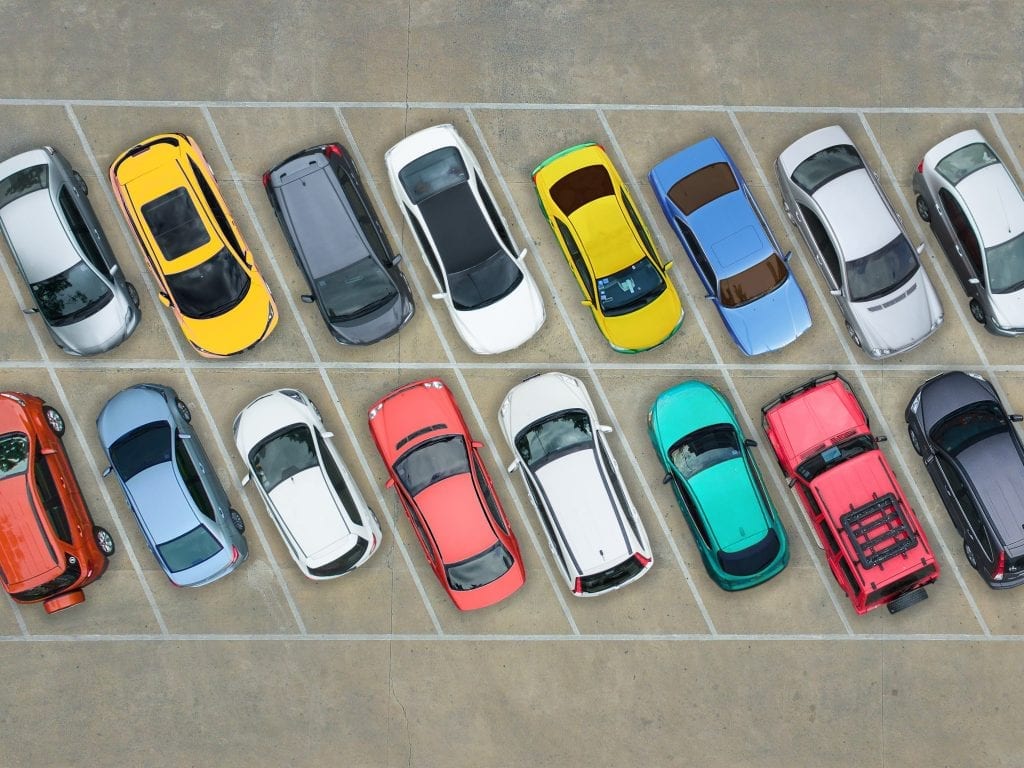 Arial view of different colour cars in car park